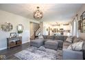 Cozy living room featuring a large sectional, stylish decor, and an open layout connecting to the kitchen at 7128 Verwood Ct, Plainfield, IN 46168