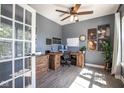 Well-lit home office with hardwood floors, ample desk space, and stylish decor for a productive workspace at 7128 Verwood Ct, Plainfield, IN 46168