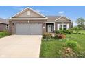 Single-Gathering home featuring brick and vinyl siding, a two-car garage, and a well-maintained front yard at 757 Carson Ln, Greenfield, IN 46140