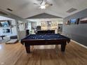 Open-concept living area with a pool table and view into the eat-in kitchen at 8460 Ferguson Cir, Avon, IN 46123