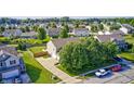 Aerial view showcasing a well-maintained backyard, a patio, and an attached two-car garage at 8557 Vyners Ln, Avon, IN 46123