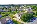 Aerial view of the backyard and house, surrounded by a vibrant neighborhood at 8557 Vyners Ln, Avon, IN 46123