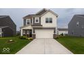 Charming two-story home with gray siding, white trim, and a spacious driveway leading to a two-car garage at 9309 Kellner St, Pendleton, IN 46064