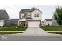 Attractive two-story home featuring a well-maintained lawn, neutral siding, and an attached two-car garage at 9309 Kellner St, Pendleton, IN 46064