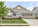 Attractive home featuring stone accents, a manicured lawn, and a two-car garage, offering curb appeal at 10814 Matherly Way, Noblesville, IN 46060