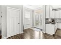 Bright entryway with wood flooring, a glass-paneled door, and neutral decor for a welcoming first impression at 10814 Matherly Way, Noblesville, IN 46060