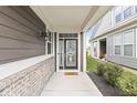 Inviting front porch with brick accents, a decorative front door, and a welcoming ambiance to greet visitors at 10814 Matherly Way, Noblesville, IN 46060