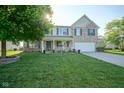 Inviting two-story home with lovely lawn and a charming front porch at 12847 Arvada Pl, Fishers, IN 46038