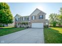 Charming two-story home with well-manicured lawn and inviting front porch at 12847 Arvada Pl, Fishers, IN 46038