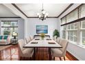 Formal dining room is complete with hardwood floors, large windows, and elegant chandelier at 12997 Bartlett Dr, Fishers, IN 46037