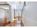 Inviting foyer featuring gleaming hardwood floors, a staircase, and ample natural light at 12997 Bartlett Dr, Fishers, IN 46037