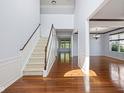 Open foyer showcases hardwood floors and staircase leading to the upper level at 12997 Bartlett Dr, Fishers, IN 46037