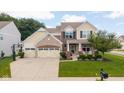 Beautiful two-story home with a brick and siding facade, three-car garage, and a well-kept lawn at 12998 Silbury Hill Way, Fishers, IN 46037