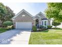 Lovely brick home featuring an attached two-car garage, manicured landscaping, and a welcoming entrance at 13161 Duval Dr, Fishers, IN 46037