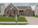 Beautiful brick home featuring a well-kept lawn, mature landscaping, and a classic mailbox near the driveway at 14332 Eddington Pl, Fishers, IN 46037