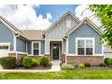 Inviting entryway showcasing brick accents, manicured lawn, and an attractive front door at 19009 Beverly Shones Ln, Noblesville, IN 46062