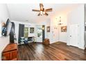 A spacious living room with wood floors, a ceiling fan, and a door leading to the outside at 20845 Summit Rd, Noblesville, IN 46062