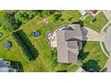 Aerial view of landscaped backyard featuring a patio with seating, a fire pit, and two trampolines at 2096 Whitetail Ct, Avon, IN 46123