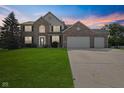Charming two-story brick home with a well-manicured lawn and a spacious three-car garage at 2096 Whitetail Ct, Avon, IN 46123