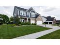 Attractive two-story home with beautiful landscaping, a long driveway, and a spacious two-car garage at 2245 Meadow Crk, Avon, IN 46123