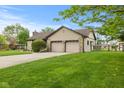 Spacious three car garage with ample parking space and well-kept landscaping at 2303 Alexandria Dr, Greenfield, IN 46140
