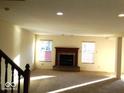 Cozy living room featuring carpet flooring, fireplace and natural light from two windows at 2931 Sentiment Ln, Greenwood, IN 46143