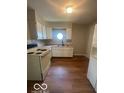 Bright kitchen with white cabinets and a window over the sink at 3026 S Rybolt Ave, Indianapolis, IN 46241