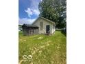 Back exterior featuring an outbuilding and grassy yard at 3026 S Rybolt Ave, Indianapolis, IN 46241
