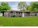 Well-kept home with manicured lawn and tidy landscaping, featuring a neutral-colored exterior at 3149 Thayer St, Indianapolis, IN 46222
