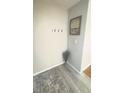 Entryway featuring hardwood flooring, neutral paint and decor, coat hooks, and accent rug at 336 Brookside Ln, Plainfield, IN 46168