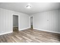 Bright, neutral living room featuring wood-look floors and panelling for a modern appeal at 410 Montgomery St, Shelbyville, IN 46176