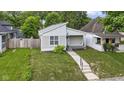 Charming single-story home with well-manicured lawn surrounded by mature trees at 4129 Cornelius Ave, Indianapolis, IN 46208