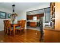 Dining room with wood floors and an adjacent kitchen at 431 N Bauman St, Indianapolis, IN 46214