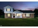 Twilight view of a charming two-story home with a cozy, illuminated front porch at 4330 S 100 E, Lebanon, IN 46052