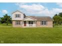 Inviting two-story home with a brick facade, vinyl siding and cozy front porch at 4330 S 100 E, Lebanon, IN 46052
