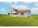 Two-story home with a brick facade, vinyl siding, attached garage, and well-kept lawn at 4330 S 100 E, Lebanon, IN 46052