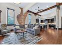 Open-concept living area with exposed brick, hardwood floors, and modern furnishings at 501 Fletcher Ave # A, Indianapolis, IN 46203