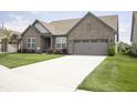 Inviting single-story brick home with attached garage and long driveway at 5081 Holborn Ave, McCordsville, IN 46055
