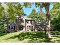 Beautiful brick home with a well manicured lawn and mature trees at 5826 Winding Way Ln, Indianapolis, IN 46220