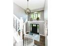 Bright foyer with a modern chandelier and hardwood floors at 5826 Winding Way Ln, Indianapolis, IN 46220
