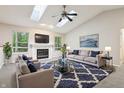 Bright living room with vaulted ceilings, skylights, fireplace, and ample seating at 5935 Oakforge Ln, Indianapolis, IN 46254