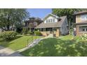 Inviting two-story home with a well-kept lawn, brick accents, and a charming front porch at 622 N Dequincy St, Indianapolis, IN 46201