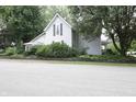 View of home with mature trees and simple landscaping at 633 N East St, Greenfield, IN 46140