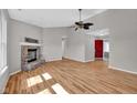 Bright living room featuring a vaulted ceiling, fireplace, hardwood floors, and an open layout at 652 White Ash Trl, Mooresville, IN 46158