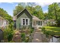 View of the exterior of a charming home with green siding and a well-manicured front yard at 761 N Holmes Ave, Indianapolis, IN 46222