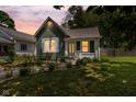 Charming home with well-maintained landscaping, green siding and inviting pathway to the front door at 761 N Holmes Ave, Indianapolis, IN 46222