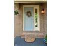 Front door close up with a wreath and exterior light fixture at 7612 Farm View E Cir, Indianapolis, IN 46256
