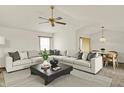 Bright living room featuring a large sectional sofa, modern coffee table, and stylish ceiling fan at 785 Cottage Ln, Greenwood, IN 46143