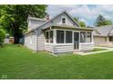 Charming bungalow-style home with a screened-in front porch and well-maintained lawn at 8912 Robey Dr, Indianapolis, IN 46234