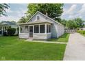 Charming bungalow-style home with a screened-in front porch and well-maintained lawn at 8912 Robey Dr, Indianapolis, IN 46234